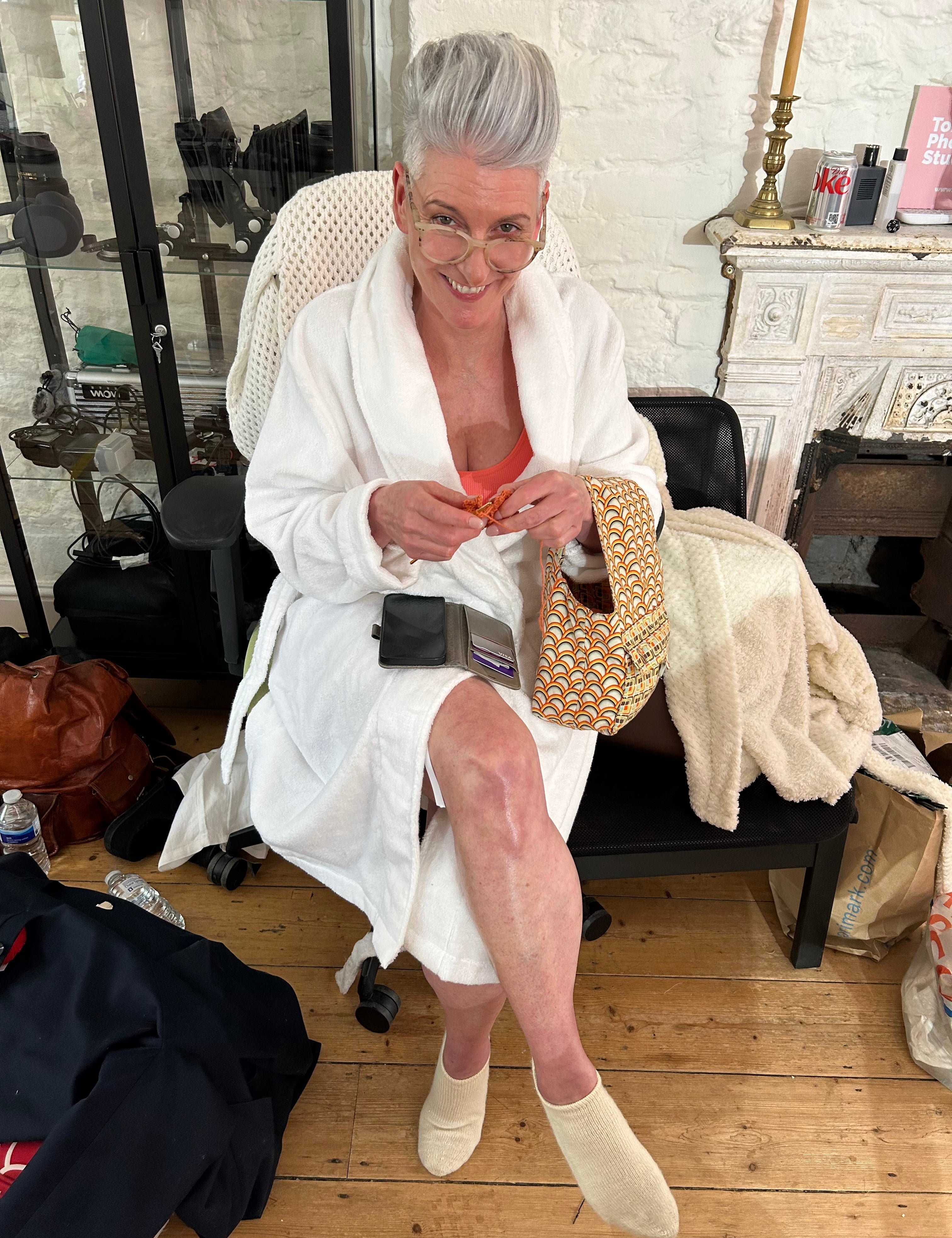 Menopause woman keeping cool in dressing gown relaxing and smiling