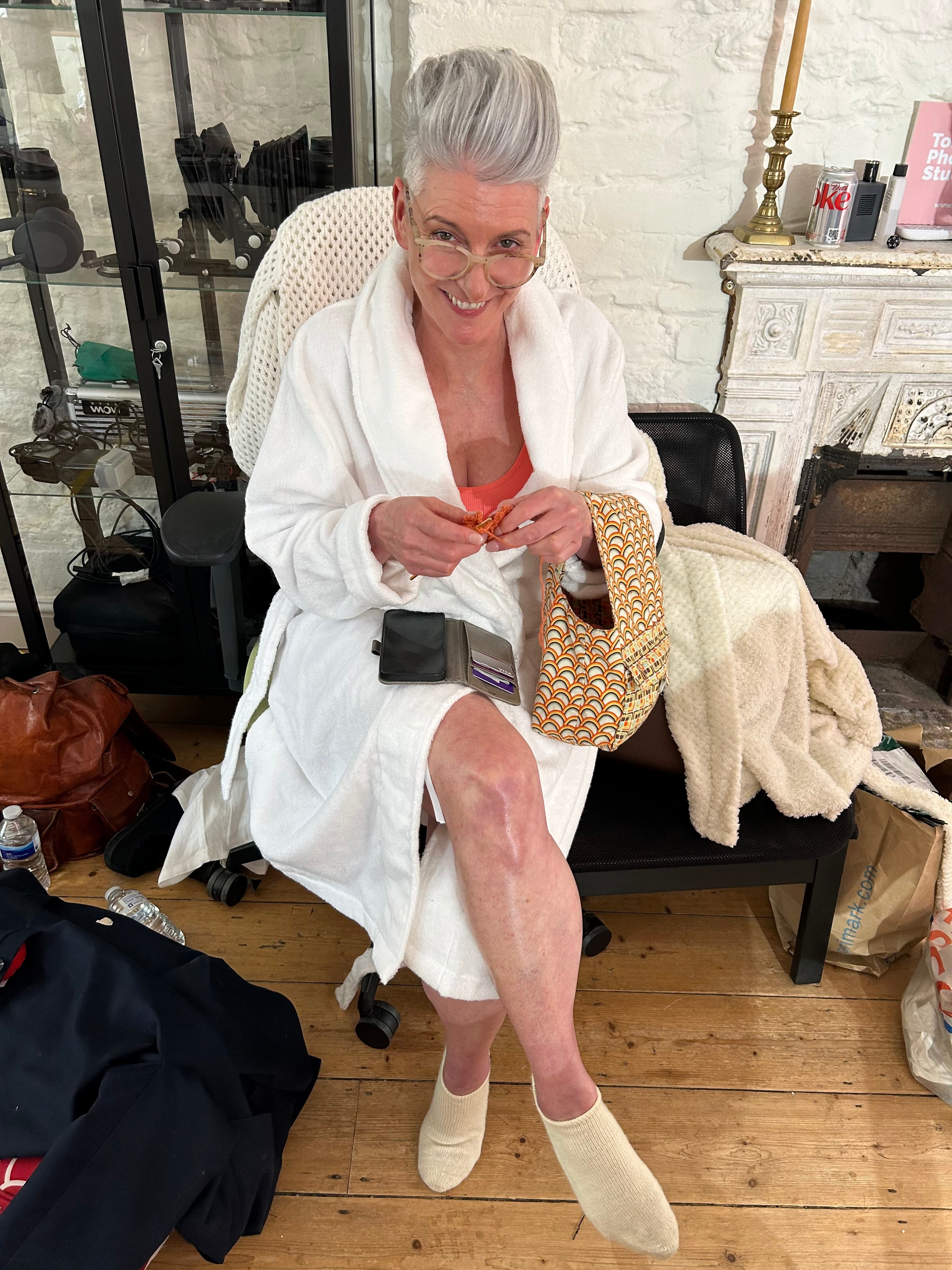Menopause woman keeping cool in dressing gown relaxing and smiling