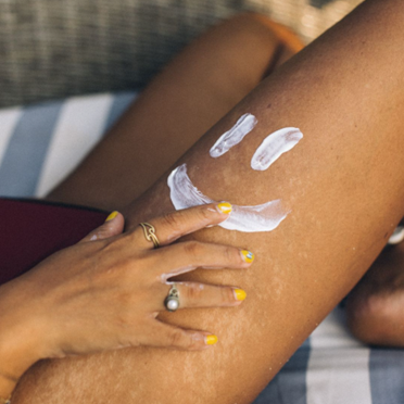 Leg with SPF Sunscreen applied as a smiley face