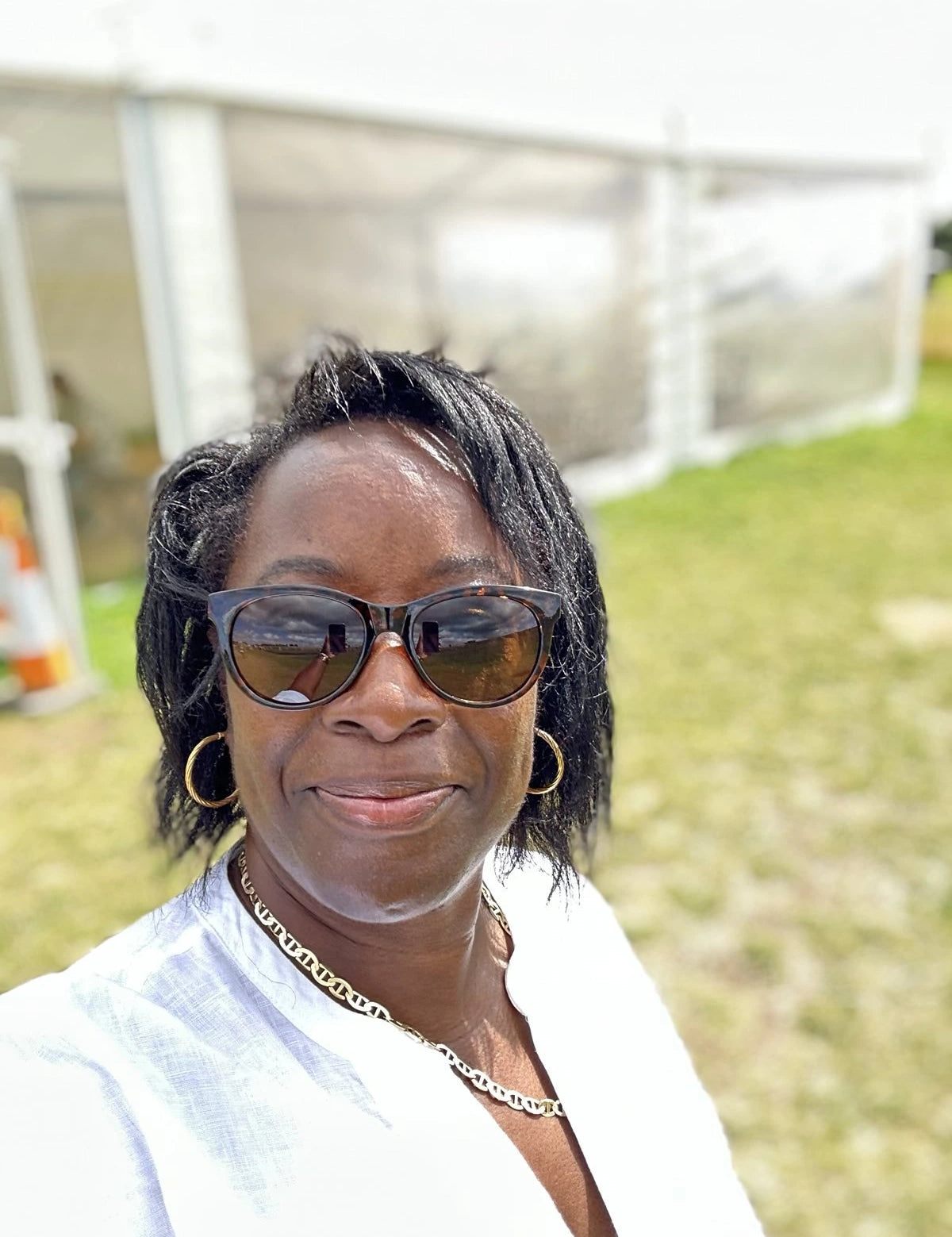 Woman in sunglasses smiling at camera for real menopause stories blog