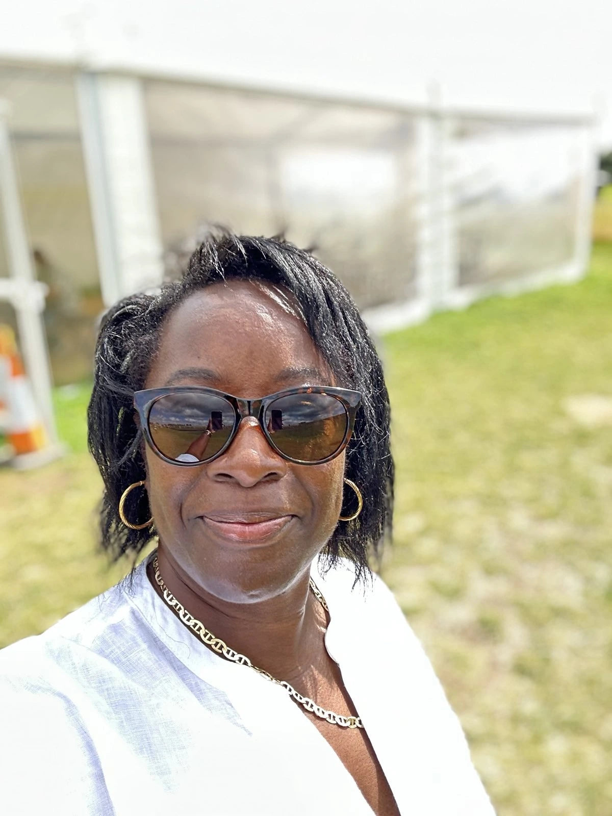 Woman in sunglasses smiling at camera for real menopause stories blog