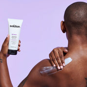 Model applying The Solution Retinol Smoothing Body Lotion
