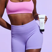Model holding The Solution Retinol Smoothing Body Lotion