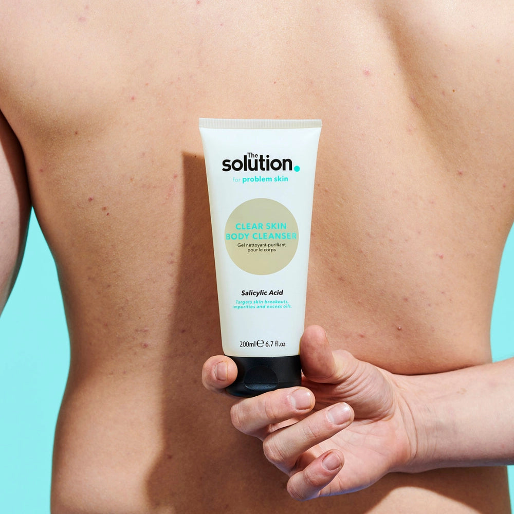 Model holding The Solution Salicylic Acid Clear Skin Body Cleanser