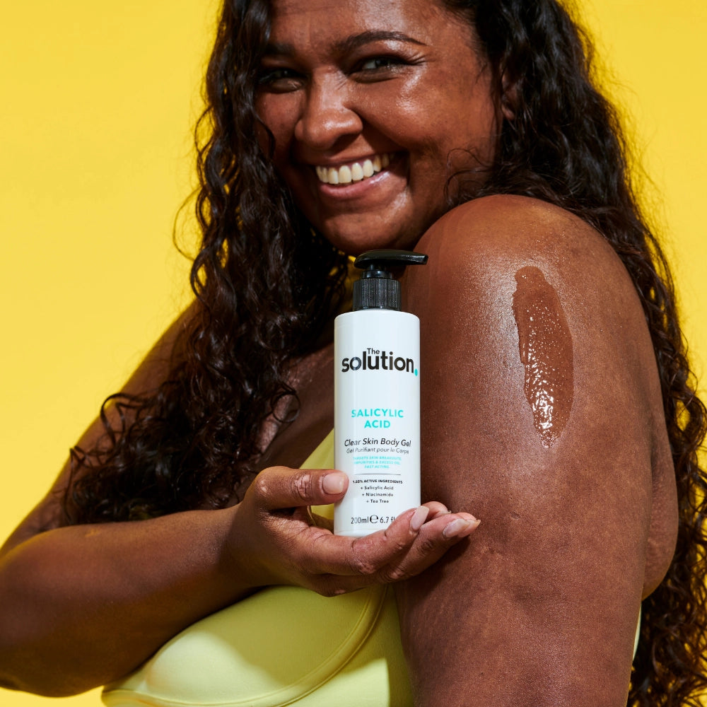 Model holding The Solution Salicylic Acid Clear Skin Body Gel