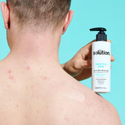 Model holding The Solution Salicylic Acid Clear Skin Body Gel