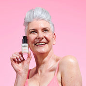 Model holding The Solution Menopause 3 In 1 Boost Serum 30ml