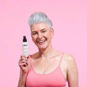 Model holding The Solution Menopause Hydrating Cooling Mist 100ml