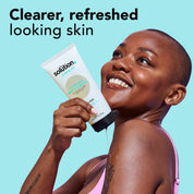 Model applying The Solution Salicylic Acid Clear Skin Body Cleanser with text: clearer, refreshed looking skin